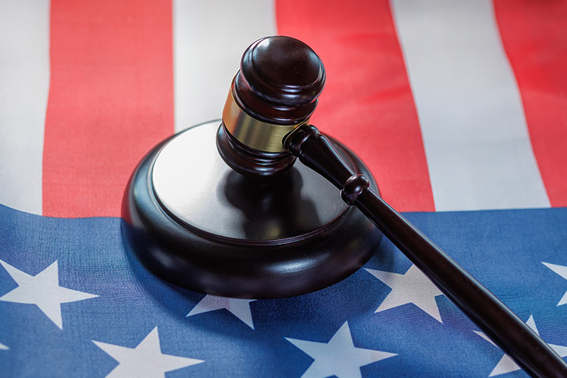Judge's gavel resting on an American flag for Carolinas state tax law guidance.