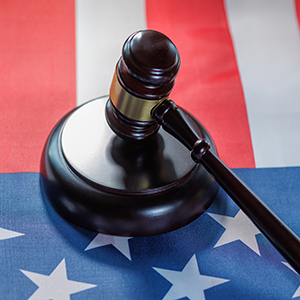 Judge's gavel resting on an American flag for Carolinas state tax law guidance.