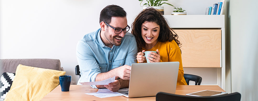 Couple reviewing documents and using a laptop, illustrating how to respond to a CP504 Notice in North or South Carolina.
