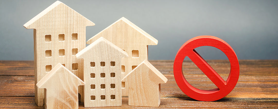 Close-up of a worker in a blue shirt filling out legal claim documents.